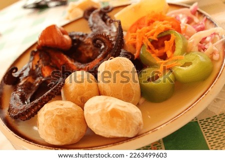 Best dish of Papas Arrugadas, grilled octopus and mixed vegetables. Top seafood in the world and in Europe. Typical restaurants of Fuerteventura Canary Islands, Spain. Royalty-Free Stock Photo #2263499603