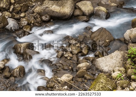 At the intersection of motion and stillness lies the beauty of nature, and the slow shutter speed photography of water flowing among the rocks captures this perfectly