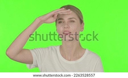 Casual Young Woman Looking Around, Searching Green Screen