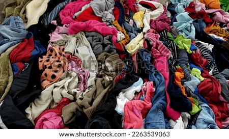 Textile Waste. A pile of old used clothes. Fast Fashion and Recycle fabric waste. High quality photo Royalty-Free Stock Photo #2263539063