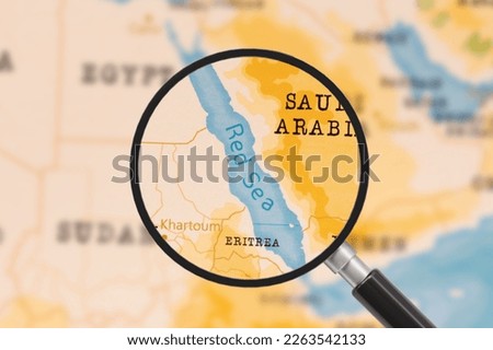 A Magnifying Glass on Red Sea of the World Map Royalty-Free Stock Photo #2263542133