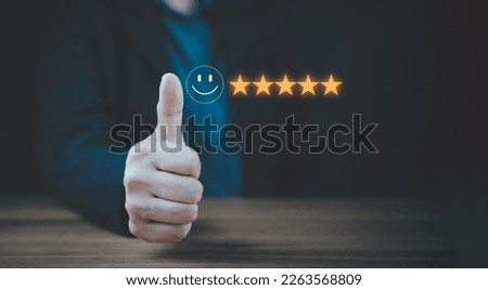 Evaluation and satisfaction concept. A thumps up that is an excellent review with unidentified model. Medium close up shot on businesswoman raised thumps up with a smile face emoticon with copy space. Royalty-Free Stock Photo #2263568809