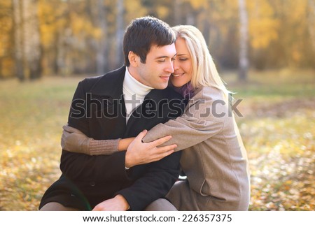 Autumn, love, relationship and people concept - happy pretty young couple in love outdoors in autumn 