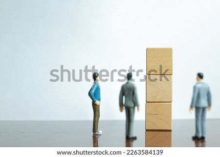 A Business Team Standing infront of Blank Wooden cubes stack for put text,word and infographic icon over white background in right corner photo with copyspace use for business,finance,marketing idea.