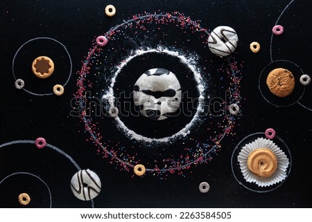 Universe of cookies, donuts and cereals. Creative photo, dark galaxy background