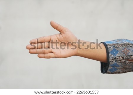 human hand reaching forward to shake hands