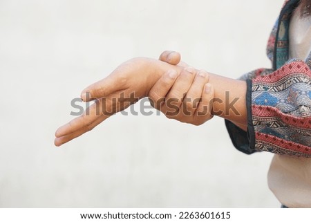 Asian woman having muscle weakness in her hands