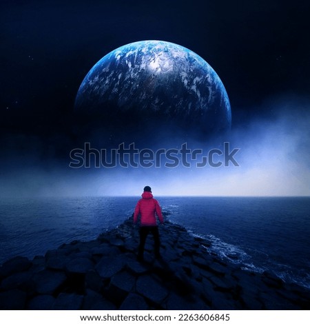 A man standing at the edge of the world looking at a new planet