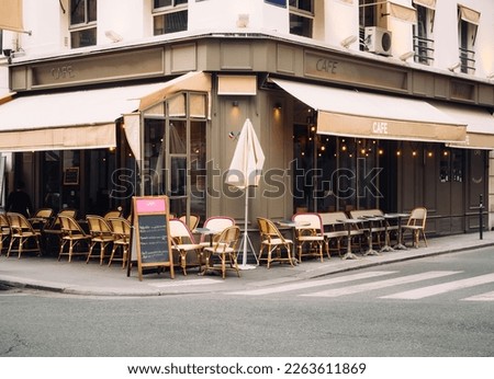 Cozy street with tables of cafe in Paris, France. Architecture and landmark of Paris. Cozy Paris cityscape Royalty-Free Stock Photo #2263611869