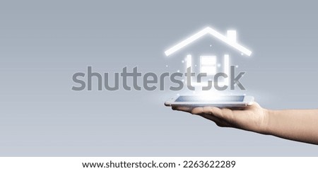 Businessman hold house icon.Smart home controlled, intelligent house, and home automation app concept.Pcb design and person with smart phone. Innovation technology internet Network Concept