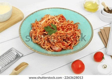 Beautiful composition with spaghetti on white wooden table in studio. Food stylist