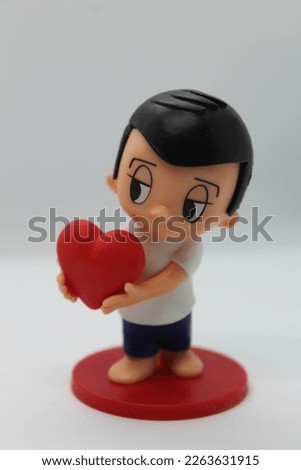 Figurine of a guy in love on a white background