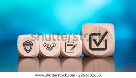 Wooden blocks with symbol of validation concept on blue background