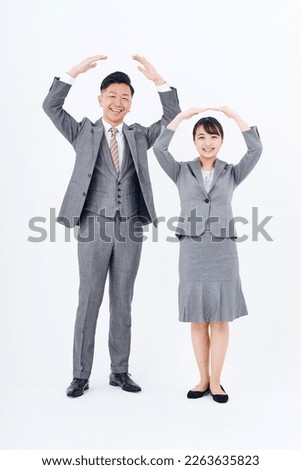 Man and woman in suits who pose for affirmation and correct answers