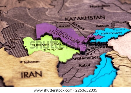 the country of Turkmenistan on the world map, wooden volume map of the world on a white background macro, close-up, shallow depth of field