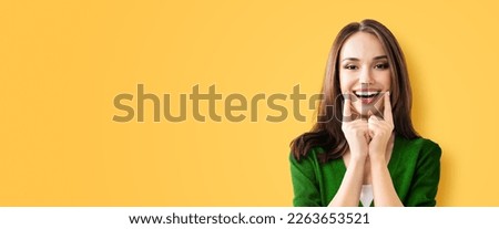 Dental dent health care concept picture - happy excited beautiful woman in green cloth show toothy smile. Portrait image of brunette girl, isolate on orange yellow background, wide banner composition