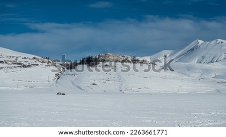 Italy, February 2023: Breathtaking view of the snowy landscape around Castelluccio di Norcia in Umbria. The concept of peace, quiet and immensity is expressed