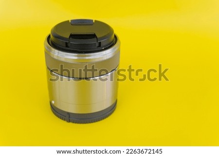 35mm macro fix lens isolated on yellow background.