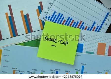 Concept of Small-cap write on sticky notes isolated on Wooden Table. Stock market concept