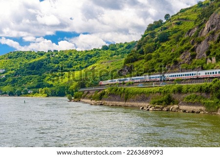 Intercity express train IC in Rhein Rhine river in Loreley, Rhein-Lahn-Kreis, Rhineland-Palatinate, Rheinland-Pfalz, Germany. Royalty-Free Stock Photo #2263689093