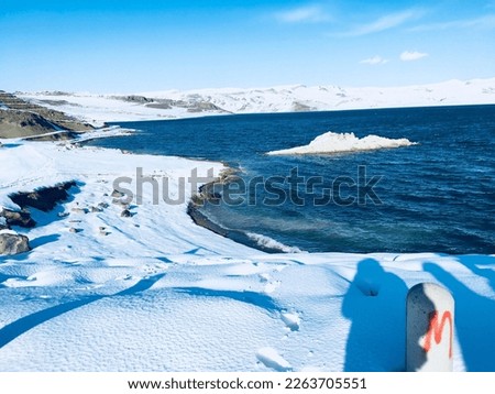 ice, snow and blue sea view, lake like, cold winter day photo