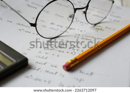Hand writing algebra equations on a paper  Royalty-Free Stock Photo #2263712097