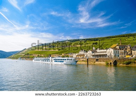 Touristic cruise passenger motor ship boat and vineyards in Ruedesheim am Rhein Rhine, Rudesheim, Rheingau-Taunus-Kreis, Darmstadt, Hessen, Germany. Royalty-Free Stock Photo #2263723263