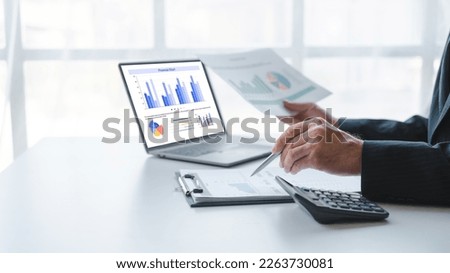 Young handsome asia business man in formal suit working with monthly report balance sheet and yearly tax of accounting to verify the account by an authorized auditor Royalty-Free Stock Photo #2263730081