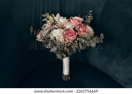 Very beautiful wedding bridal bouquet, made of white roch and austoma, and yellow daisies, green casting of eucalyptus.  Wedding, engagement. Bride and groom. Bride's wedding bouquet. Royalty-Free Stock Photo #2263756669