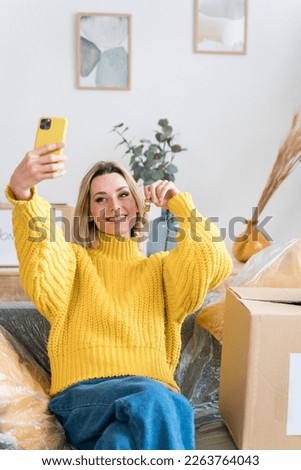 Happy woman taking selfie on smartphone