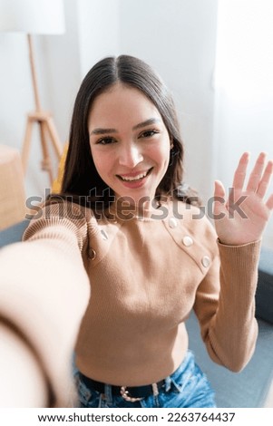 Happy woman having a videocall at home Royalty-Free Stock Photo #2263764437