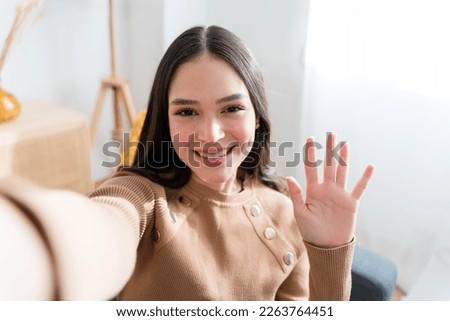 Happy woman having a videocall at home Royalty-Free Stock Photo #2263764451