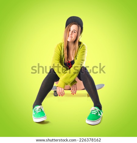 Pretty young girl wearing urban style with skateboard