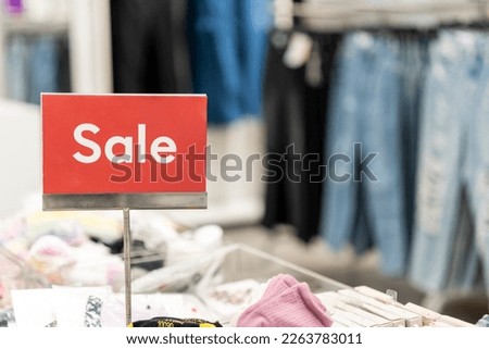 an information sign at a clothing store with the words 'sale' written on it