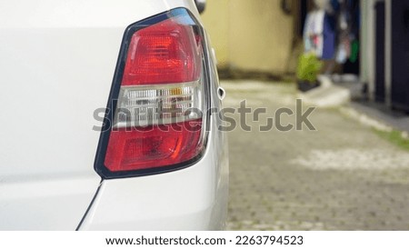 close up rear stop lamp of a white car