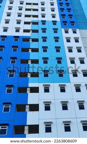 The building is painted blue and has lots of windows