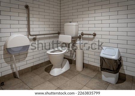 Unisex disabled toilet suite room Royalty-Free Stock Photo #2263835799