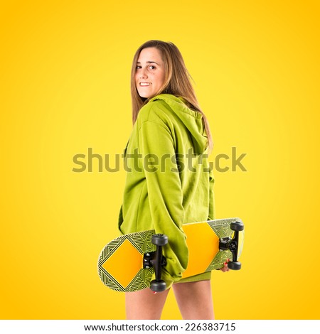 Skater with green sweatshirt over yellow background