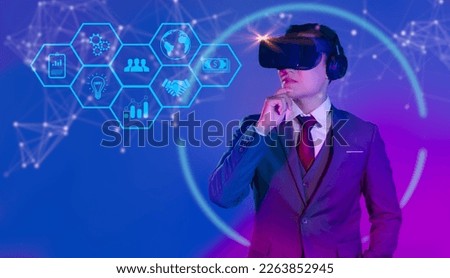 Metaverse technology concept. Asian businessman wear vr goggles headset looking virtual digital interface. Internet of things.