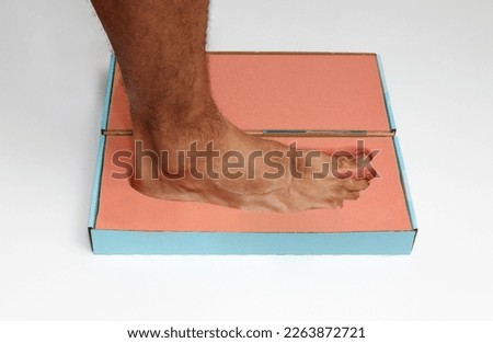 Orthopedic foam footprints or mold measurement from block to create custom made orthotics or orthopedic insoles Royalty-Free Stock Photo #2263872721