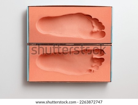 Orthopedic foam footprints or mold measurement from block to create custom made orthotics or orthopedic insoles Royalty-Free Stock Photo #2263872747