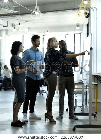 Creative people, meeting and collaboration on whiteboard for planning, brainstorming strategy or schedule at office. Group of employee workers in teamwork, ideas or project management for startup Royalty-Free Stock Photo #2263877889