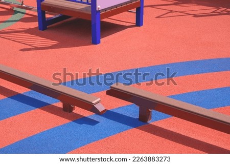 Colorful orange and blue Rubber Floor with Kids Balance Beams Equipment in Outdoors Playground area Royalty-Free Stock Photo #2263883273