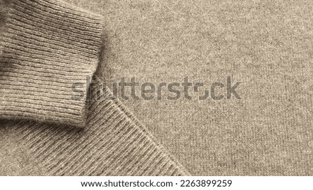  Natural cashmere brown fabric. Knitwear. Cashmere, wool. Texture of natural wool fabric. Beige cashmere sweater. Royalty-Free Stock Photo #2263899259