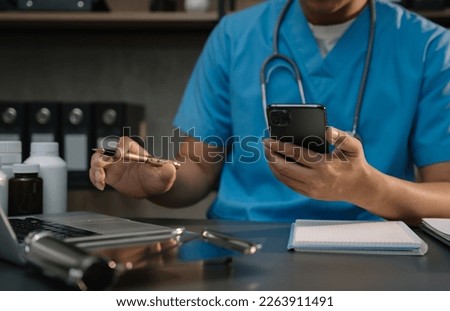 Medical technology concept. Doctor working with mobile phone and stethoscope and digital tablet laptop in modern office.