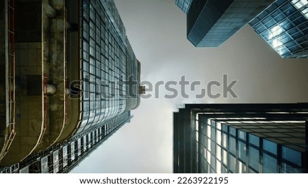 looking up at corporate high-rise office buildings in a foggy night