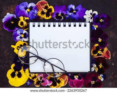 Bright flowers and a place for your congratulatory message. Close-up, view from above. No people. Concept of preparation for a holiday. Congratulations for relatives, friends and colleagues