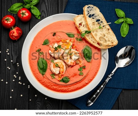 Delicious cold tomato soup or gazpacho with shrimps. Serving food in a restaurant. Healthy food concept. Photo for the menu Royalty-Free Stock Photo #2263952577