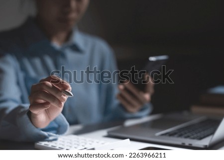 Close up hand of business woman pointing a pen at copy space
