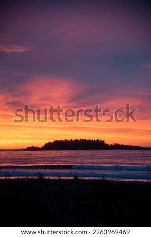 Vibrant sunrise over ocean and island